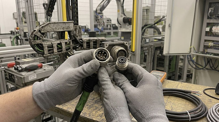 Diagram showing multimeter probes testing shield continuity on an M23 cable